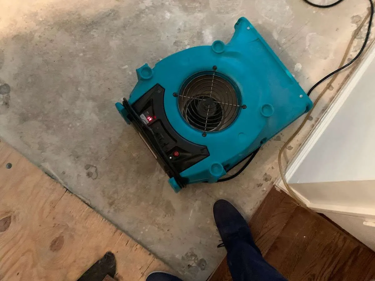 Air mover drying subfloor during Commercial Water Damage Restoration in Galloway